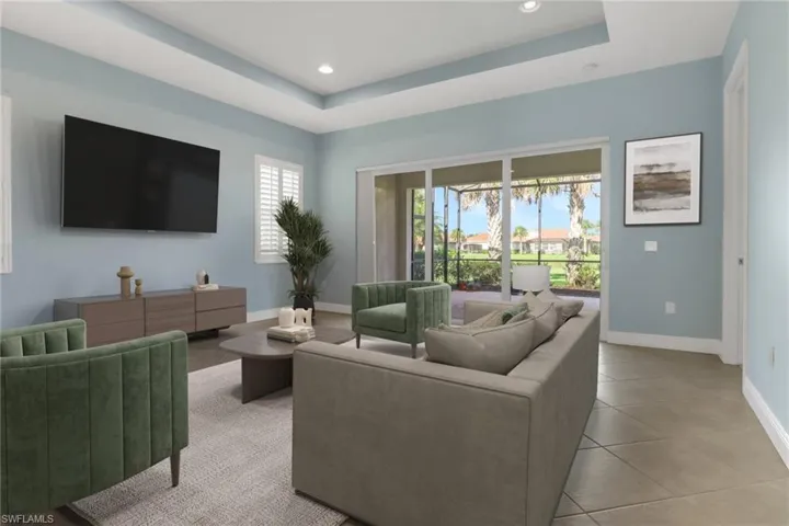 Virtually Staged Living room featuring a raised ceiling, light tile flooring, and recessed lighting