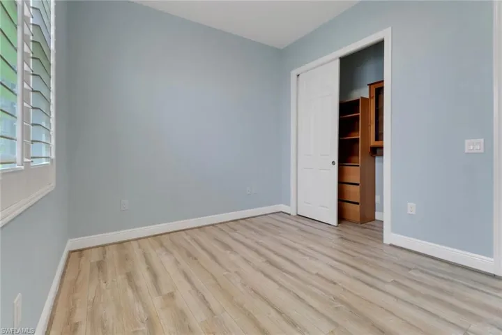 Unfurnished bedroom featuring wood finished floors and a closet