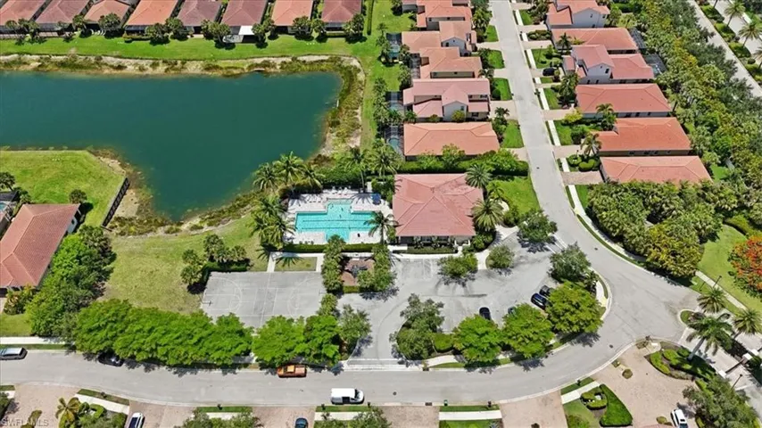 Aerial overview of the community pool, clubhouse, basketball courts, fitness center and parking lot.