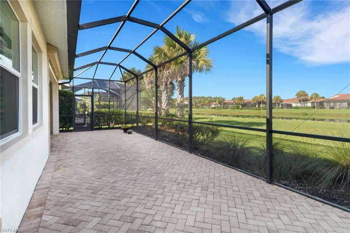 View of patio featuring screen enclosure