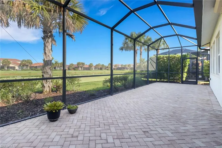 View of patio with a lanai and a lake view
