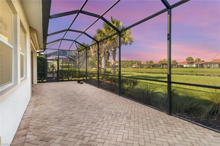 Twilight View of patio featuring a screen lanai