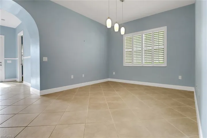 Living/Den featuring arched walkways and light tile patterned floors