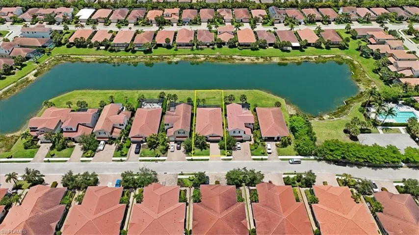 Aerial perspective of residential area with a nearby body of water