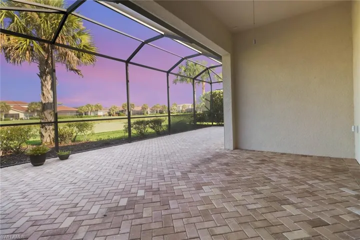 Twilight View of patio with screen enclosure and a residential view