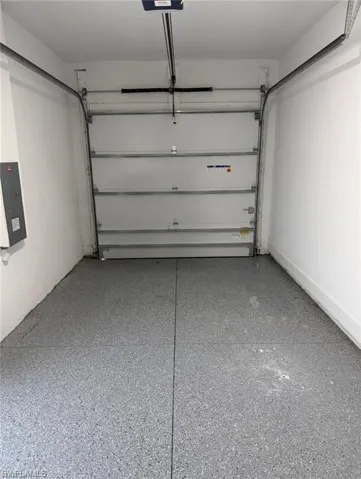 Single-car garage with a gray speckled epoxy floor finish