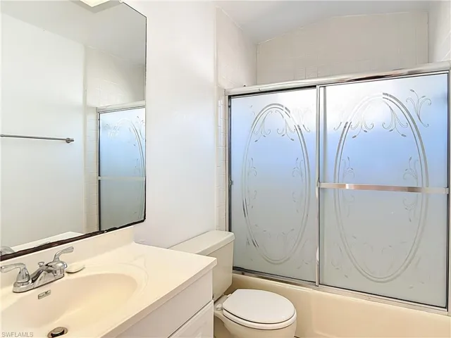 Bathroom with vanity and shower / bath combination with glass door