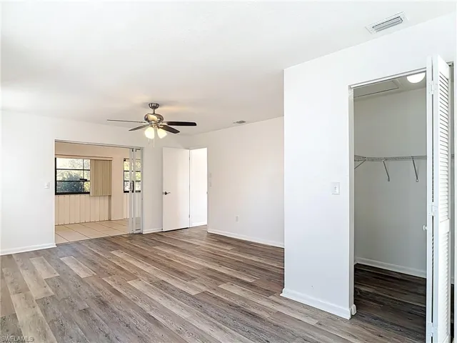 Unfurnished living room featuring light wood finished floors and ceiling fan
