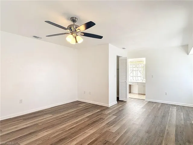 Spare room with a ceiling fan and wood finished floors
