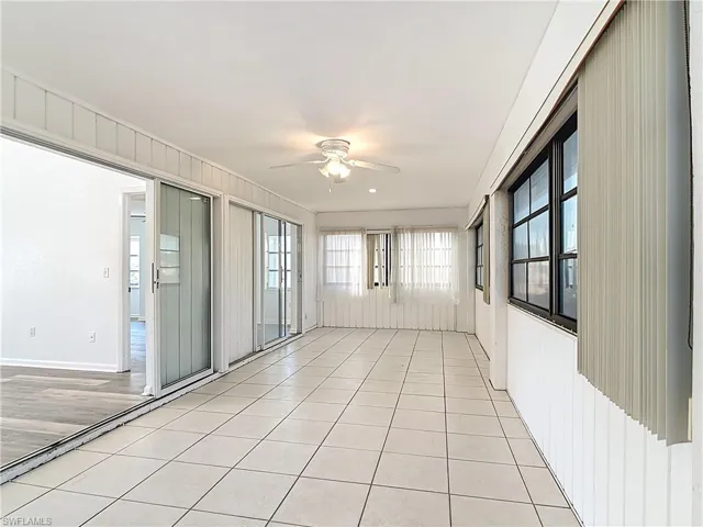 Unfurnished sunroom with ceiling fan