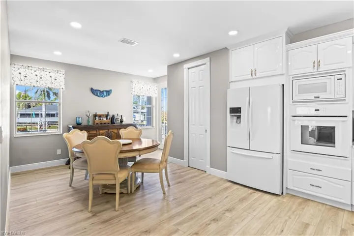 Dining room featuring a wealth of natural light, visible vents, light wood-style flooring, and baseboards