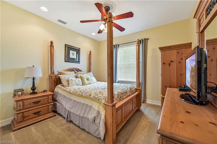 Bedroom featuring visible vents, recessed lighting, baseboards, light colored carpet, and ceiling fan