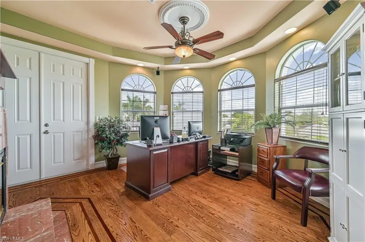 Office featuring light wood finished floors, ceiling fan, and baseboards