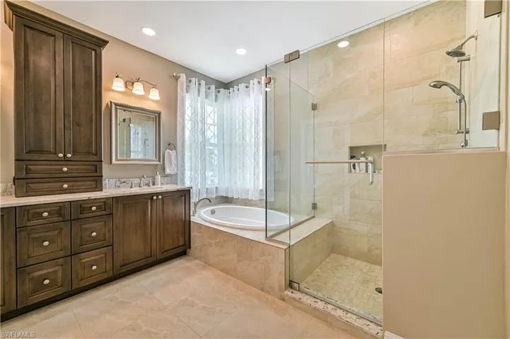 Bathroom with vanity, recessed lighting, tile patterned flooring, a shower stall, and a bath