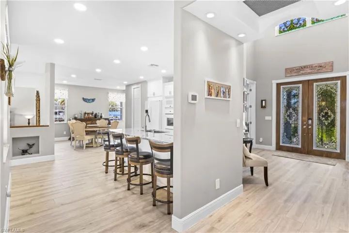 Foyer featuring visible vents, light wood-style flooring, recessed lighting, french doors, and baseboards