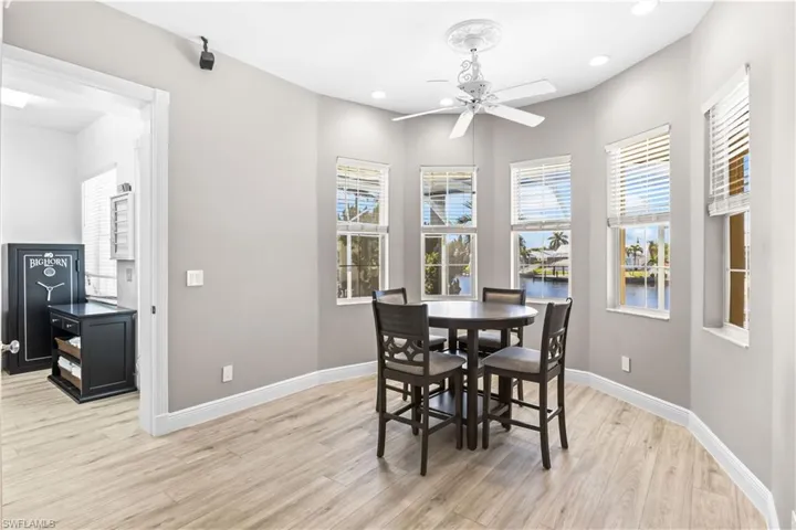 Dining area with light wood-style flooring, recessed lighting, a healthy amount of sunlight, and baseboards