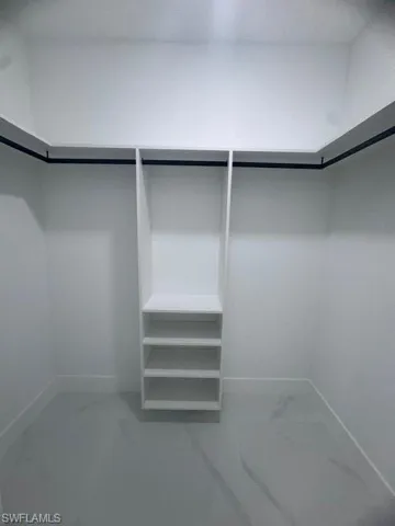 Spacious closet with marble finish floors
