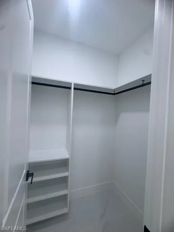 Spacious closet with marble finish floors
