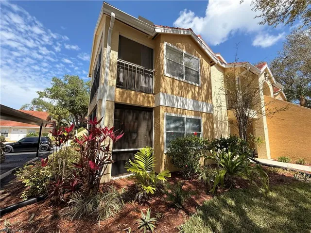View of front of home with a sunroom and a balcony