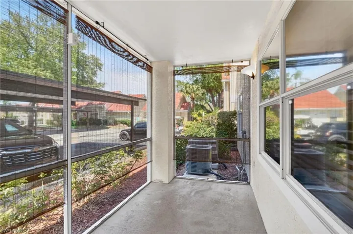 Unfurnished living room featuring a wainscoted wall, suspended lighting, a ceiling fan, and wood tiled floors