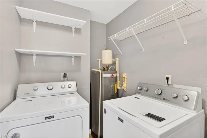 Unfurnished bedroom featuring a barn door, light wood-type flooring, a ceiling fan, and ensuite bathroom