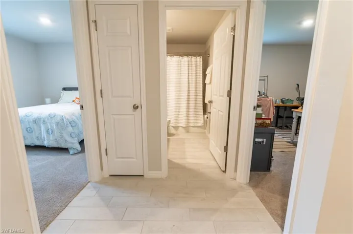 Hall featuring light carpet