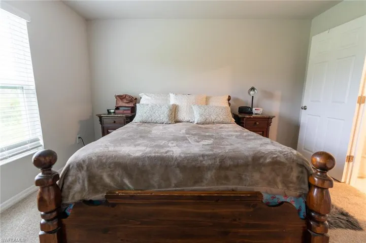 Bedroom with multiple windows and carpet floors