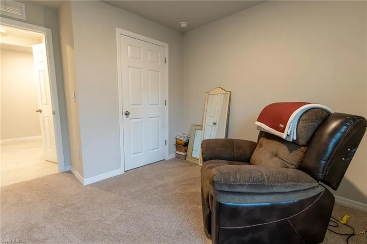 Sitting room featuring light colored carpet