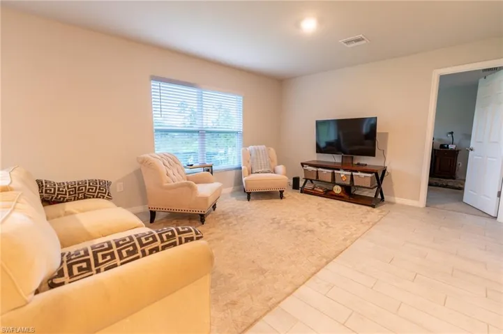 Living room with light hardwood / wood-style floors