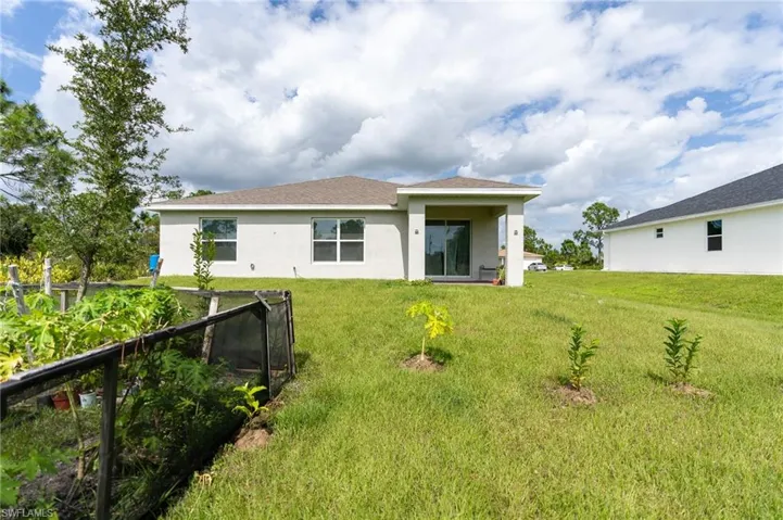 Back of property with a yard