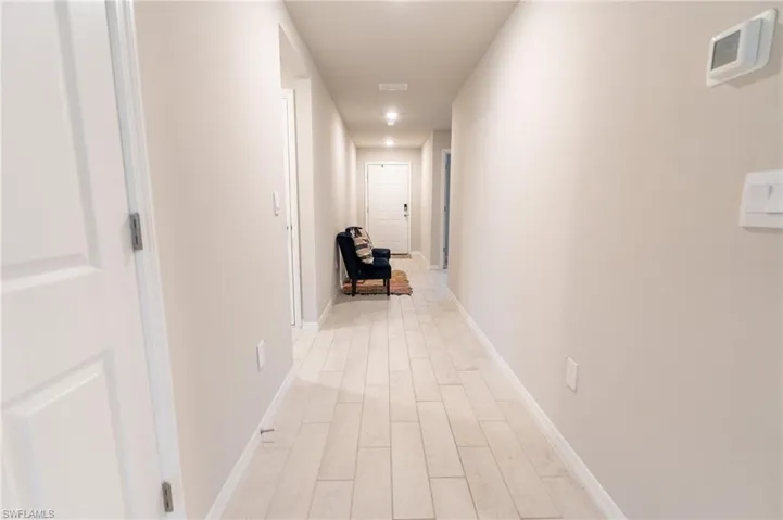 Corridor with light wood-type flooring