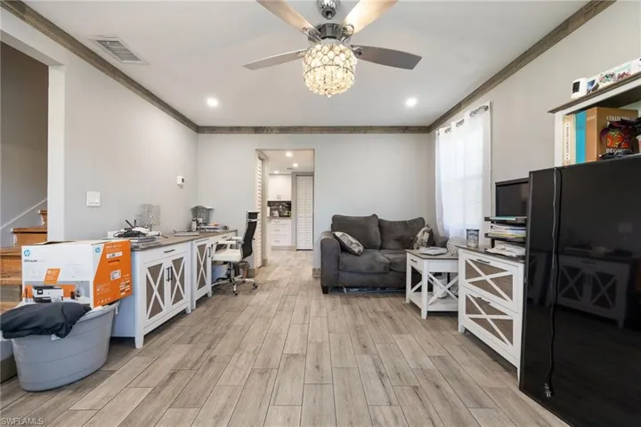 Office area featuring ceiling fan, ornamental molding, light wood-style floors, and recessed lighting