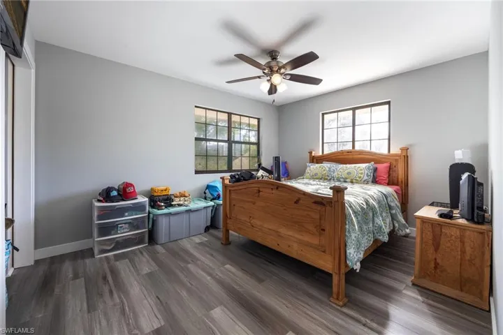 Bedroom with wood finished floors and a ceiling fan
