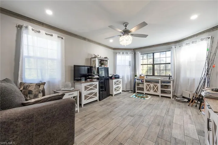 Office with ornamental molding, a ceiling fan, light wood finished floors, and recessed lighting