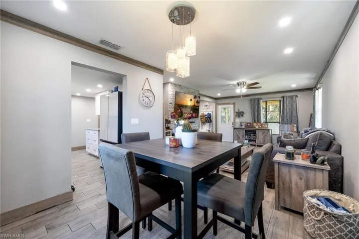 Dining room featuring crown molding, light wood finished floors, recessed lighting, a ceiling fan, and baseboards