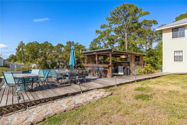 Deck featuring outdoor dining space and a yard