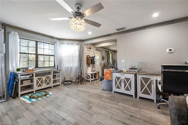 Office featuring ornamental molding, a ceiling fan, and wood finished floors