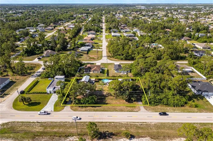 Aerial view of residential area with property parcel outlined