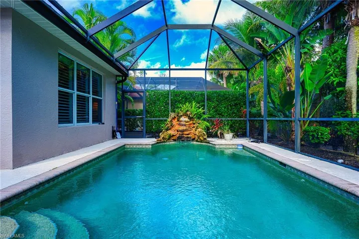 View of pool featuring a lanai