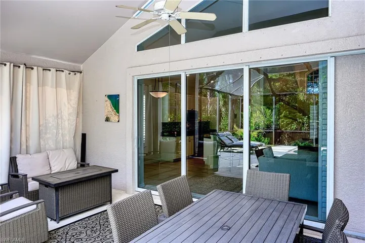 Unfurnished sunroom featuring ceiling fan and vaulted ceiling