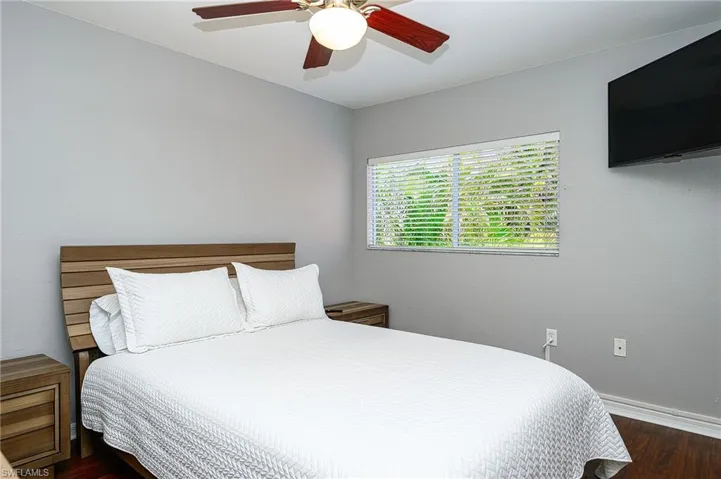 Bedroom featuring ceiling fan and dark hardwood / wood-style floors