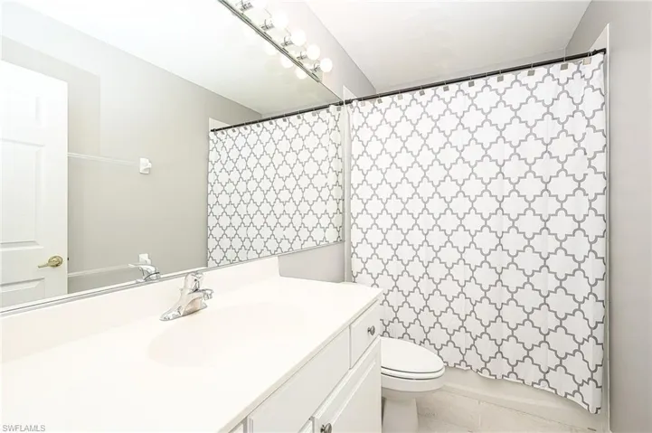 Bathroom with tile patterned flooring, vanity, and toilet