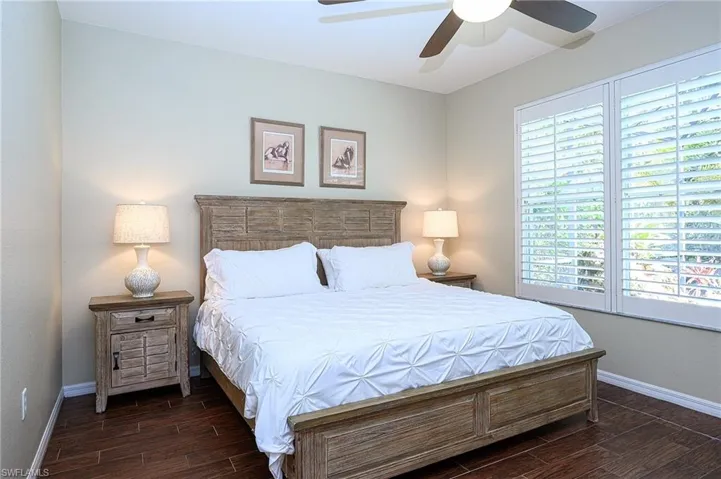 Bedroom featuring dark hardwood / wood-style flooring and ceiling fan