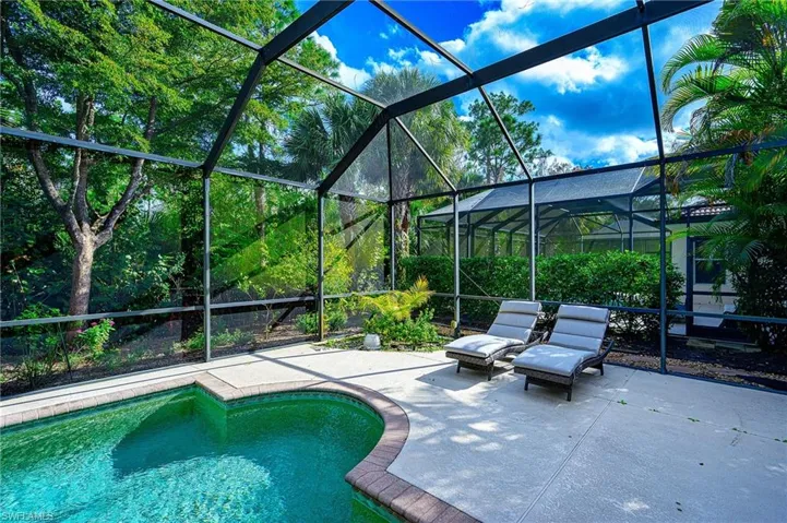 View of swimming pool with a patio area and a lanai