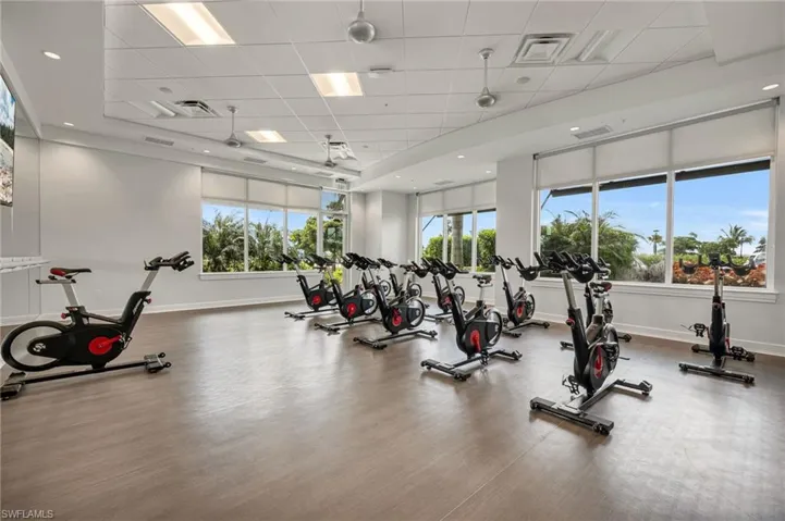 Gym featuring a drop ceiling and wood-type flooring