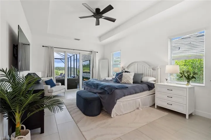 Bedroom featuring a tray ceiling, access to exterior