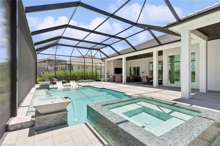 View of pool featuring an in ground hot tub, a lanai, a patio, and ceiling fan
