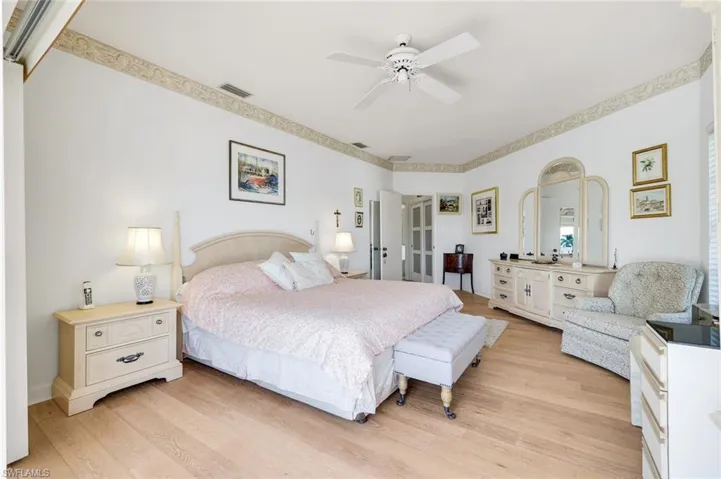 Shown with a King Bedroom Set, Wood Flooring, Sliders to Screened Lanai
