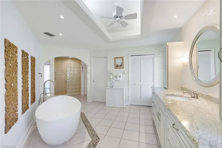 Shown with Raised Granite Counters and 2 Window Benches- w/custom shoe storage, View of 2 Closet Locations, Archway to Second Bath Area,  Easy Entry- Extra Large Shower