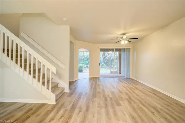 Unfurnished living room with light hardwood / wood-style floors and ceiling fan